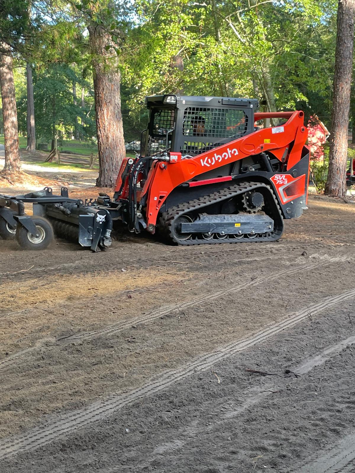 Kubota equipment with grading attachment